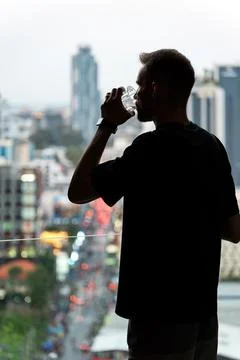 Man Drinking Alone By Window. Alcohol And Loneliness Concept. Stock Photos
