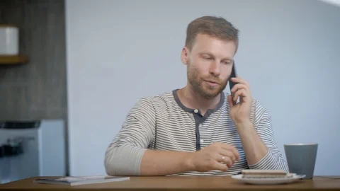Man drinking and speaking on smartphone Stock Footage 94025929