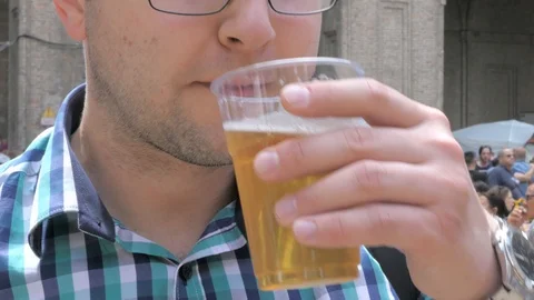 Man drinking bear at parma street food fair Stock Footage 90113851