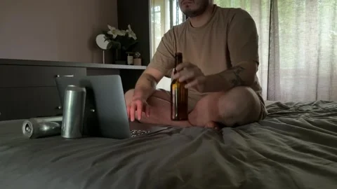 Man Drinking Beer and Browsing Laptop in Dark Room Stock Footage 310511399