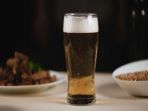 Man is drinking beer and eat toast Video stock 84772353