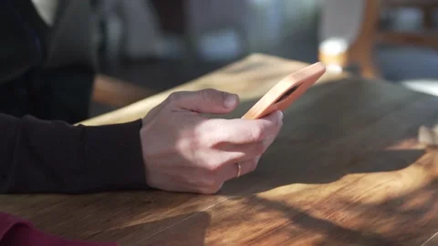 A man drinking beer and typing a message in a mobile phone Stock Footage 233317355