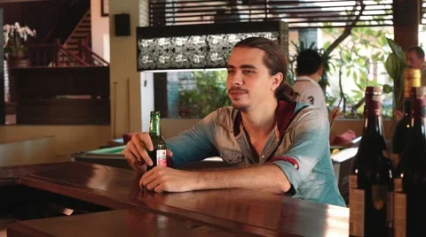 Man drinking beer in a bar 動画素材 65207379