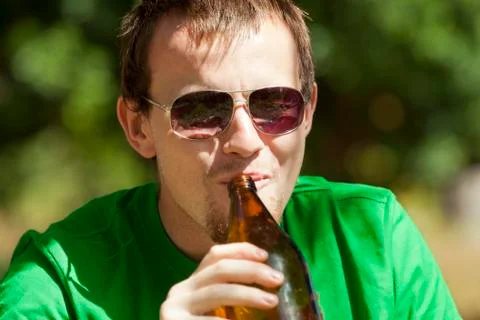 Man drinking beer from bottle Stock Photos