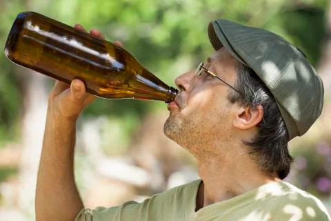 Man drinking beer from bottle Stock Photos