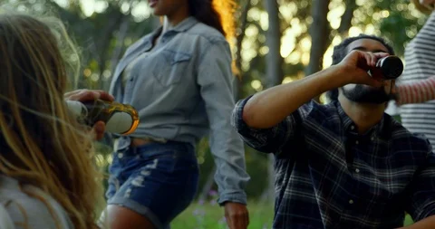 Man drinking beer at camping in the forest 4k Stockbeeldmateriaal 102776271