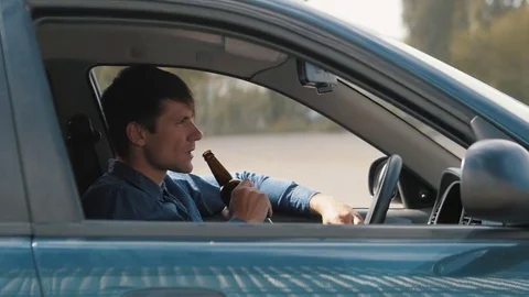 Man drinking beer in car. Drunk driver Stock Footage 75496152