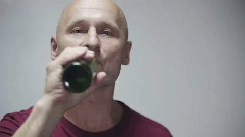 Man drinking beer at gray background Video stock 53169491