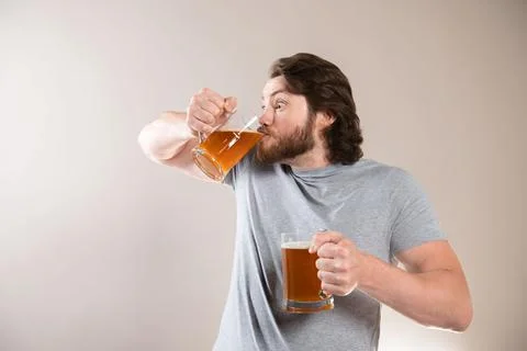 Man Drinking Beer Isolated On Light Gray Background Stock Photos