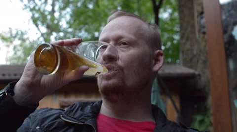 Man Drinking Beer at an Outdoor Cafe Stock Footage 62909497