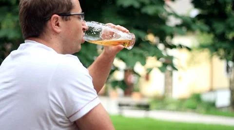 Man drinking beer outdoors Stock Footage 7902345