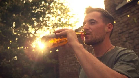 Man drinking beer outside Stock Footage 102896158