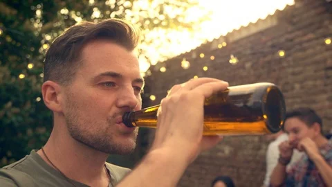 Man drinking beer outside Stock Footage 102896167