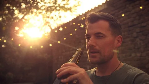 Man drinking beer outside Stock Footage 102896316