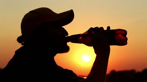 Man drinking beer at sunset Stock Footage 40433748