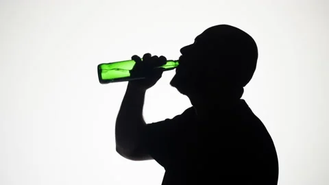 Man drinking beer on white background. Shadow silhouette of male person Stock Footage 197193713