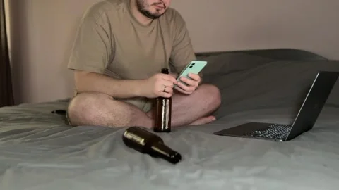 Man Drinking Beer with White Cat Passing in Room Stock Footage 310511270