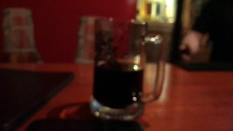 Man drinking black beer in a bar. Blur. defocus Video stock 108864690
