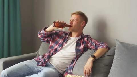 Man drinking a bottle of beer at home. Stock Footage 221261289