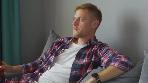 Man drinking a bottle of beer at home. Stock Footage 221398168