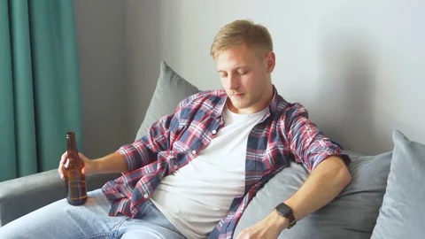 Man drinking a bottle of beer at home. Stock Footage 221398930