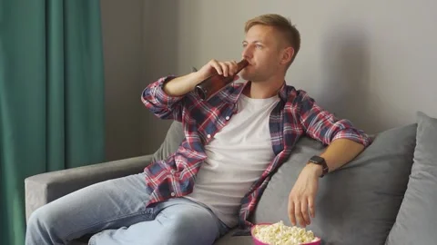 Man drinking a bottle of beer at home. Stock Footage 221399456