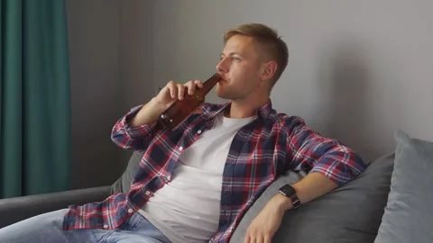 Man drinking a bottle of beer at home. Stock Footage 221399756