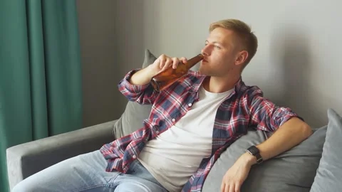 Man drinking a bottle of beer at home. Stock Footage 221399895