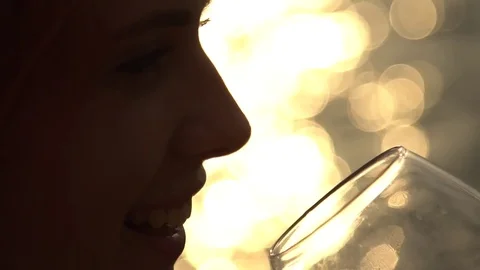 Man drinking bottle of wine during sunset near sea, slow  motion Stock Footage 80599081