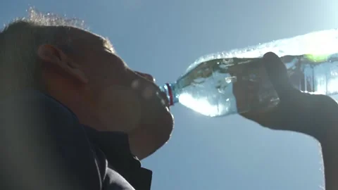 Man drinking bottled water under sun Stock Footage 221125622