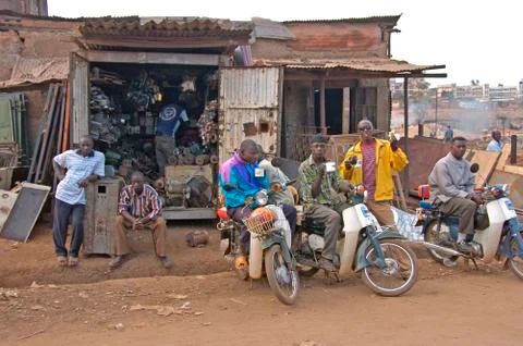 Man drinking caffe in front of a garage. Fotos de archivo
