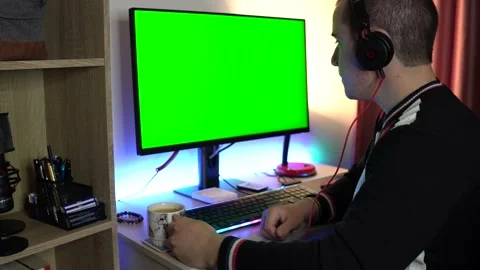 Man is Drinking Coffe and Looking at a Green Screen Stock Footage 194244756