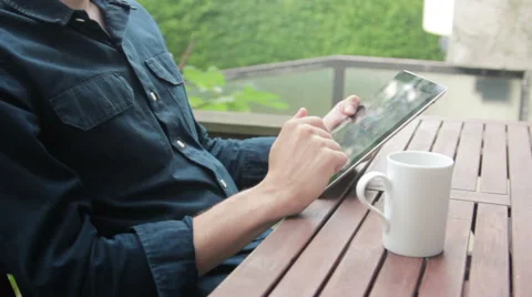 Man Drinking coffee and reading the news on tablet Stock Footage 40665339