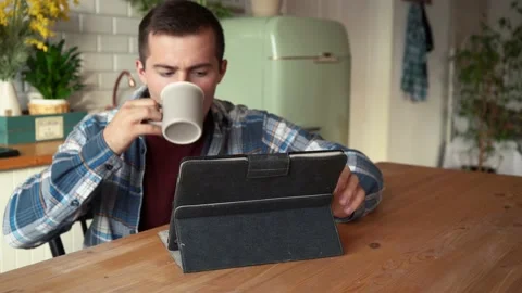Man drinking coffee and working using tablet Stock Footage 158769868