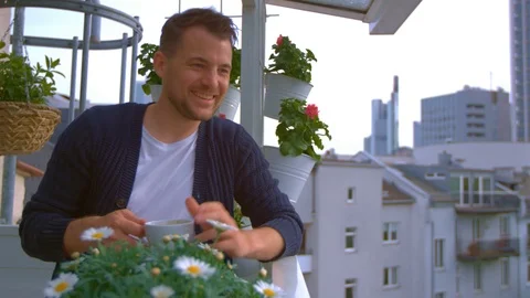 Man drinking coffee on balcony Stock Footage 103142477