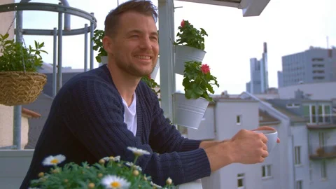 Man drinking coffee on balcony Stock Footage 103142501