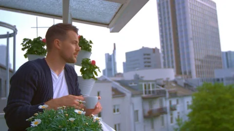 Man drinking coffee on balcony Stock Footage 103142514