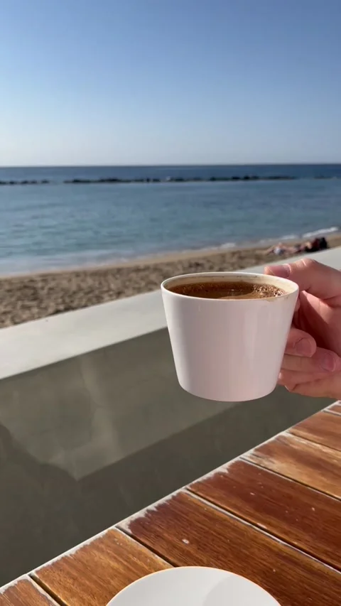 Man drinking coffee in beach cafe with sea view. HD Stock Footage 229537241