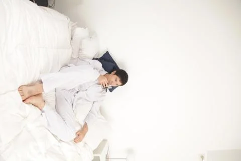 Man drinking a coffee on the bed 스톡 사진