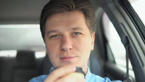 A man is drinking coffee in a car. Stock Footage 81821005