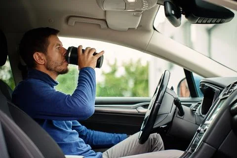 Man drinking coffee in car Stock Photos