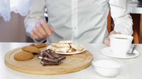 Man Drinking Coffee with Chocolate and Cookies Stock Footage 85612071