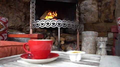 Man Drinking Coffee Cup By Fireplace In Winter In Slow Motion Vidéo 105886591
