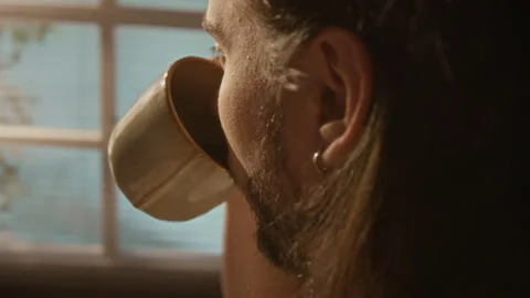 Man Drinking Coffee Looking out Window during Work Break Stock Footage 337499940