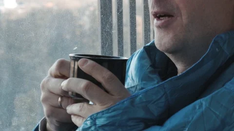 Man drinking coffee in the morning in the kitchen at home close up. He froze and Stock Footage 99366059