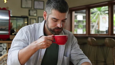 Man drinking coffee from red mug. Stock Footage 273794452