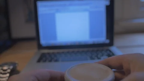 Man drinking coffee in shop whilst working on laptop Stock Footage 85653941