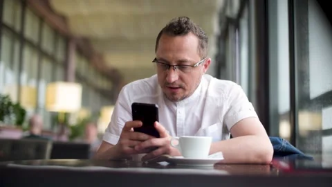 The man is drinking coffee. Slow Motion. Vertical footage. Stock Footage 156191163