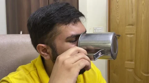 Man drinking coffee from stainless steel mug and then looking at camera Stock Footage 242044916