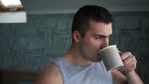 Man drinking coffee standing by the window Stock Footage 143993927
